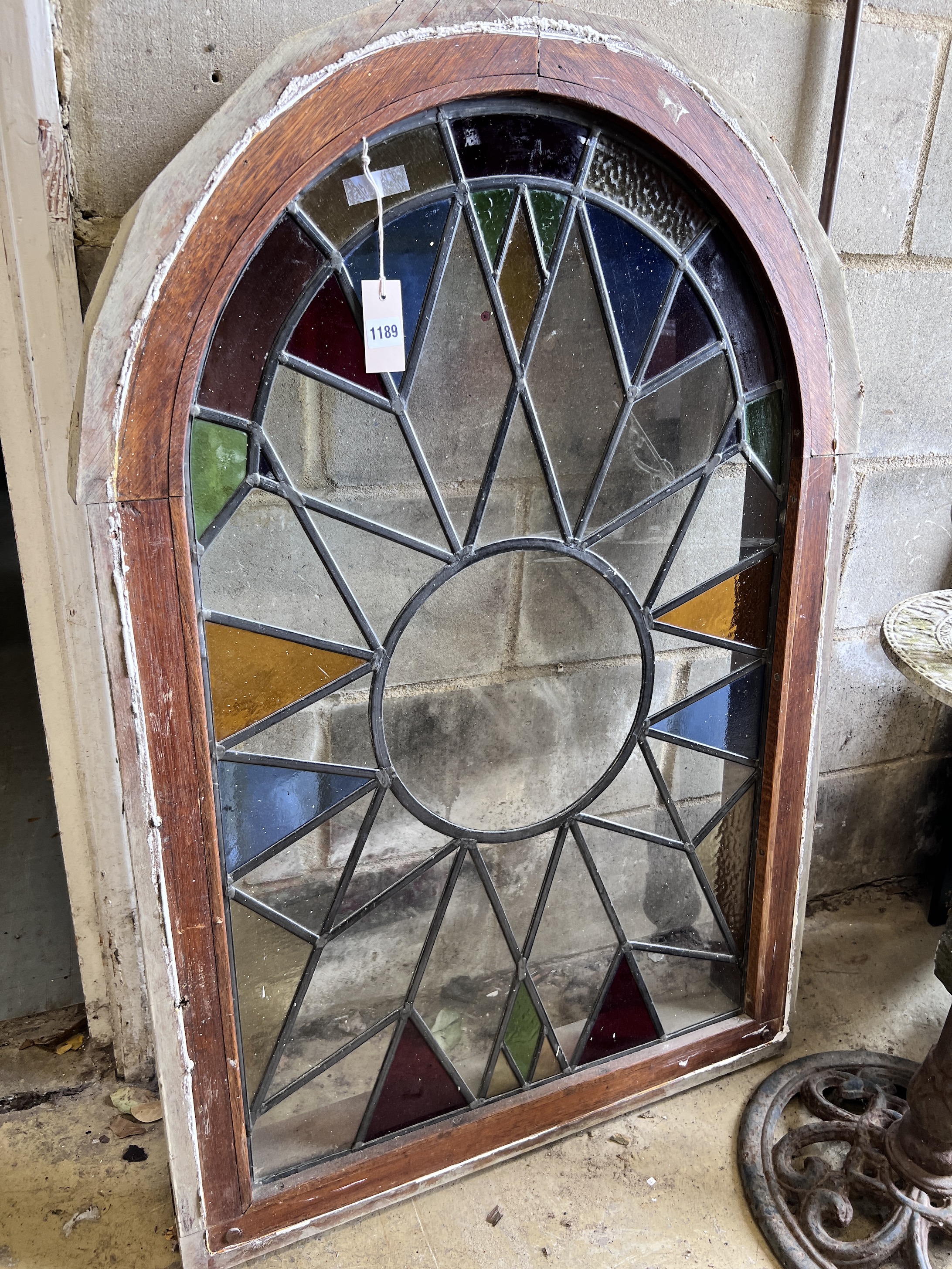 An arched stained glass window, height 110cm, width 76cm